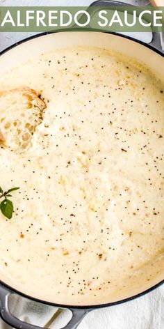 a skillet filled with alfredo sauce on top of a table