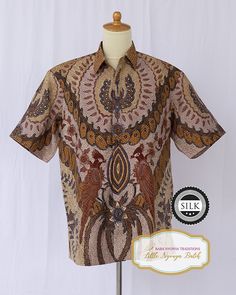 Peranakan Baba Hand-drawn Batik Shirt. Short Sleeve on Textured Silk. Size: XL Material: Textured silk Motif: Flowers/ Butterflies/ Birds Technique: Full hand-drawn batik Detail: Hidden button & chest pocket Other: Lining inside For more details and products, please check www.littlenyonyabatik.com Shipping information: Kindly furnish your contact number for shipping purposes. This information is essential and must be provided as per the courier's requirements to prevent any potential delays in t Silk Short Sleeve Printed Shirt, Traditional Multicolor Printed Shirt, Traditional Printed Shirt For Festivals, Traditional Batik Print Tops For Festive Season, Traditional Batik Print Tops For Festive Occasion, Traditional Brown Printed Top, Traditional Patterned Tops With Motif, Batik Shirt, Shirt Short Sleeve