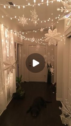 a hallway decorated with snowflakes and lights for the holiday season is seen in this undated video