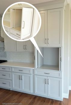 an empty kitchen with white cabinets and drawers on the wall next to a stove top oven