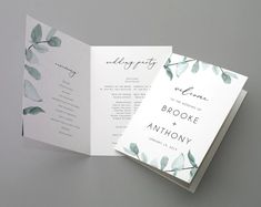 an open wedding program booklet with greenery on the front and back cover is shown