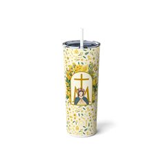 a yellow and white cup with an image of a woman holding a cross on it