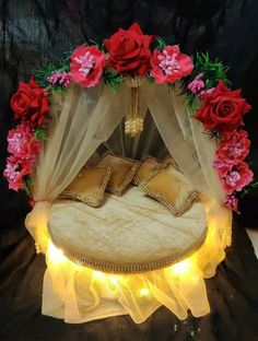 a bed with flowers on it and lights in front of the bedspread that has been made to look like a canopy