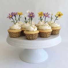 cupcakes decorated with flowers on a cake plate