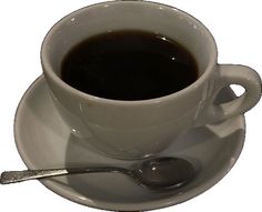 a cup of coffee on a saucer with a spoon