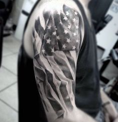 a man's arm with an american flag tattoo on it