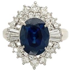 Simply Beautiful! Blue Sapphire and Diamond Art Deco Revival Platinum Ring. Centering a securely set Oval Sapphire, weighing approx. 3.34 Carat, surrounded by Diamonds, weighing approx. 1.00tcw. Hand crafted Platinum mounting. Approx. Dimensions: 1.03” l x 0.77” w x 0.72” h. Ring size 6.5, we offer ring resizing. Ideal worn alone or as an alternative Engagement ring. In excellent condition, recently professionally cleaned and polished. More Beautiful in real time! Sure to be admired…A must have Art Deco Sapphire Jewelry Gia Certified, Gia Certified Sapphire Cluster Jewelry, Gia Certified Oval Collectible Ring, Vintage Gia Certified Sapphire Jewelry, Collectible Oval Sapphire Ring In Platinum, Collectible Oval Sapphire Ring With Diamonds, Oval Sapphire Ring With Diamonds For Collectors, Collectible Oval Sapphire Diamond Ring, Blue Platinum Jewelry For Collectors