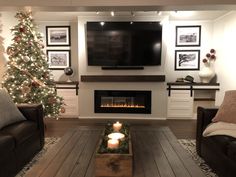 a living room filled with furniture and a christmas tree in front of a flat screen tv