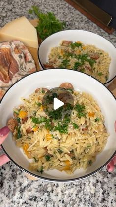 two bowls filled with food on top of a counter