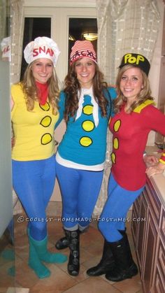 three women dressed in costumes posing for the camera