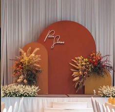 an image of a stage set up for a wedding ceremony with flowers on the side