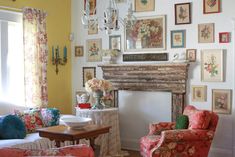 a living room filled with furniture and pictures on the wall