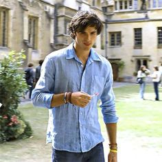 a young man walking in front of a building