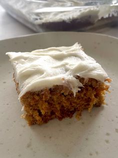 a piece of cake sitting on top of a white plate next to a plastic bag