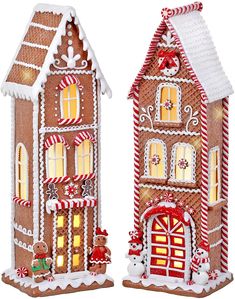 two gingerbread houses with lights and candy canes