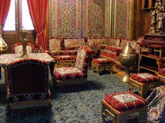 an ornately decorated living room with red and gold furniture