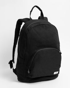 a black backpack sitting on top of a white surface