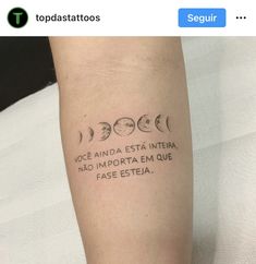 a person with a tattoo on their arm that has three phases of the moon in it