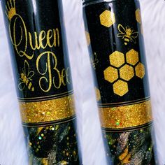 two black and gold tumbles with glitter on them