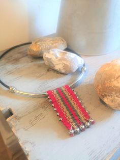 an assortment of jewelry on a table next to some rocks