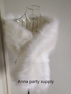 a white fur coat hanging on a clothes hanger with the words anna party supply above it