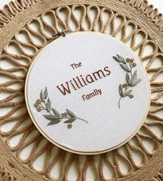 the williams family hand embroidery pattern on a white hoop with brown lettering and green leaves