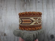 Native American bracelet brown moose leather . The leather is lined and offers an incomparable comfort. I beaded on a loom and sewn piece on the wristband . This bracelet will fit a wrist as 6 inches or more. If you want other length or other colors, please , send me a request for personalization. Each of our creations is inspired by nature . Thank you and enjoy ! Seed Bead Loom, American Bracelet, Bead Loom Bracelet, Native American Beadwork Patterns, Native American Men, Native American Bracelets, American Men, Loom Bracelet, Native American Beadwork