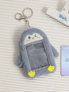 a key chain with a stuffed animal in the shape of a cell phone