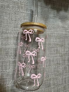 a glass jar with pink bows on it