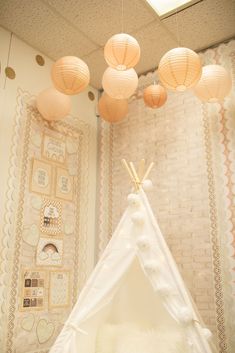 a teepee tent with lights hanging from the ceiling