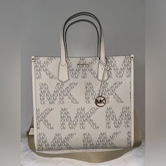 100% Authentic Guaranteed Brand New With Tags Michael Kors Maple Large Ns Logo Tote Vanilla/Cream Msrp $ 398.00 Style # 38h3g7mt3y Color: Vanilla/Cream Details - Large Mk Logo Print Throughout - Dual Top Handles - 5.75" Drop - Goldtone Hardware - Adjustable & Removable Crossbody Strap - 14" - 22.5" Drop - Hanging Mk Leather Charm - 14.25" W X 14.25" H X 5" D - Inside Has Large Zip Pocket, 2 Slip Pockets - Imported Beige Logo Shoulder Bag For Errands, Cream Logo Bag For Daily Use, Beige Shoulder Bag With Logo For Shopping, Beige Logo Shoulder Bag For Shopping, Cream Rectangular Shoulder Bag With Logo, Cream Logo Tote Shoulder Bag, Cream Tote Shoulder Bag With Logo, Cream Shoulder Bag With Logo For Shopping, Cream Rectangular Logo Shoulder Bag