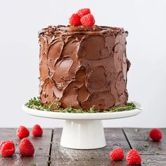 a chocolate cake with raspberries on top