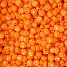 orange beads with white letters on them