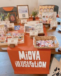 there are many cards and pictures on display at this table with the words mova illustration