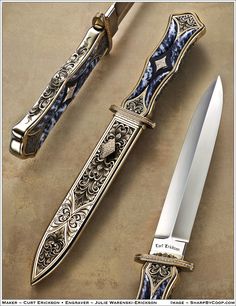 an ornate knife is sitting on the table next to it's sheathed blade