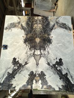 a marble table top with black and white designs on it