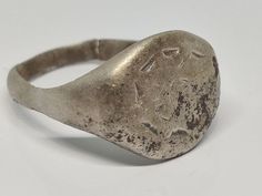 East Roman silver signet ring. A kind of ornament is depicted on the shield of the ring. I assume that this ring also served as a seal. Material: silver. OBJECT: Ring, seal SIZE: 19mm x 22mm x 3mm. Ring guard: 15mm x 13mm. Inner hole diameter: 18mm. Weight 5 g Private collection. The ring is damaged, you can see it in the photo. This is a beautiful and rare Roman ring, decorated with ancient Roman ornament, the object itself is very well preserved. This is a very well preserved item. Belongs to the later Roman period 100-400 BC. Please see the pictures carefully for yourself, each item is in the same condition as shown in the pictures. Please see my other listings and antiques for sale, I am very happy to negotiate prices. Silver Symbolic Stamped Signet Ring, Silver Stamped Symbolic Signet Ring, Classic Silver Signet Ring For Ceremonial Occasions, Antique Silver Signet Ring For Ceremonial Use, Ancient Style Silver Ring For Gift, Antique Silver Signet Ring With Polished Finish, Silver Signet Ring With Coat Of Arms, Ancient Style Engraved Silver Rings, Silver Engraved Rings In Antique Style