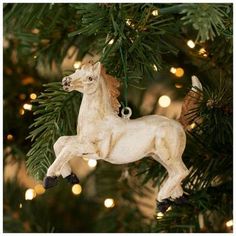 a white horse ornament hanging from a christmas tree