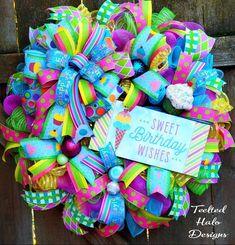 a colorful birthday wreath with a sign on it