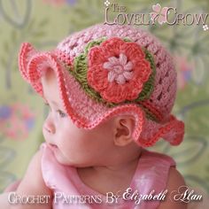 a baby wearing a crochet hat with flowers