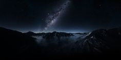 the night sky is filled with stars and clouds as seen from high up in the mountains