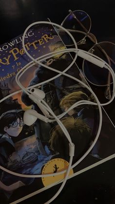 the harry potter book with headphones attached to it's ear cord and an image of hogwarts