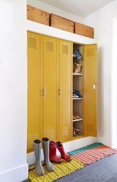 two yellow lockers with rain boots on the floor