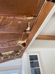 the inside of a house that has been gutted with duct tape and wood beams