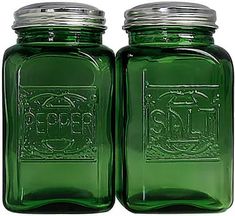 two green glass jars with metal lids