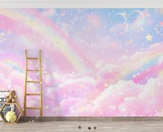 a room with a ladder, teddy bear and rainbow mural on the wall next to it