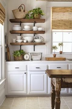 the kitchen is clean and ready to be used for cooking or baking, with open shelving on the wall