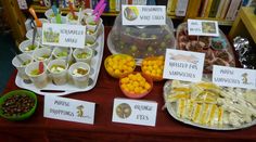 a table topped with lots of different types of foods and desserts next to each other