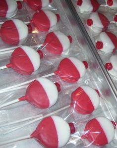 red and white marshmallows in plastic wrappers on a tray with the words fishing bobbers chocolate covered