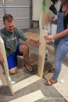 a man and woman are working on some wood